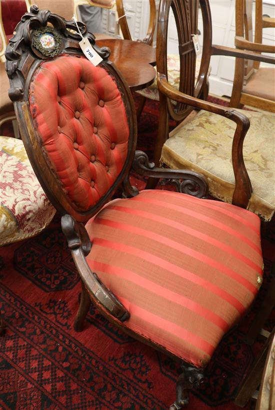 A Victorian carved walnut salon chair, inset with porcelain plaques